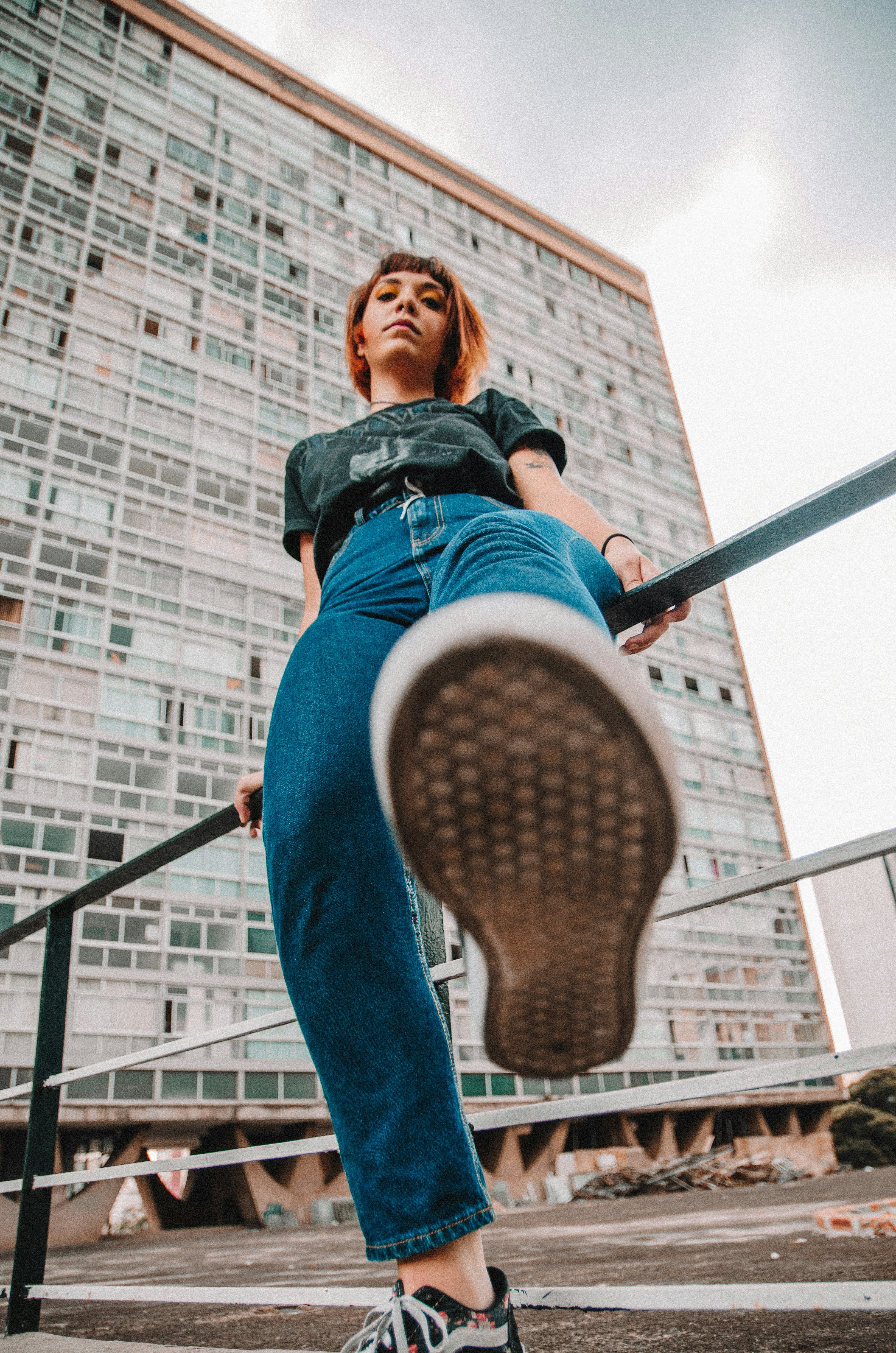 low angle view of woman sits on rail